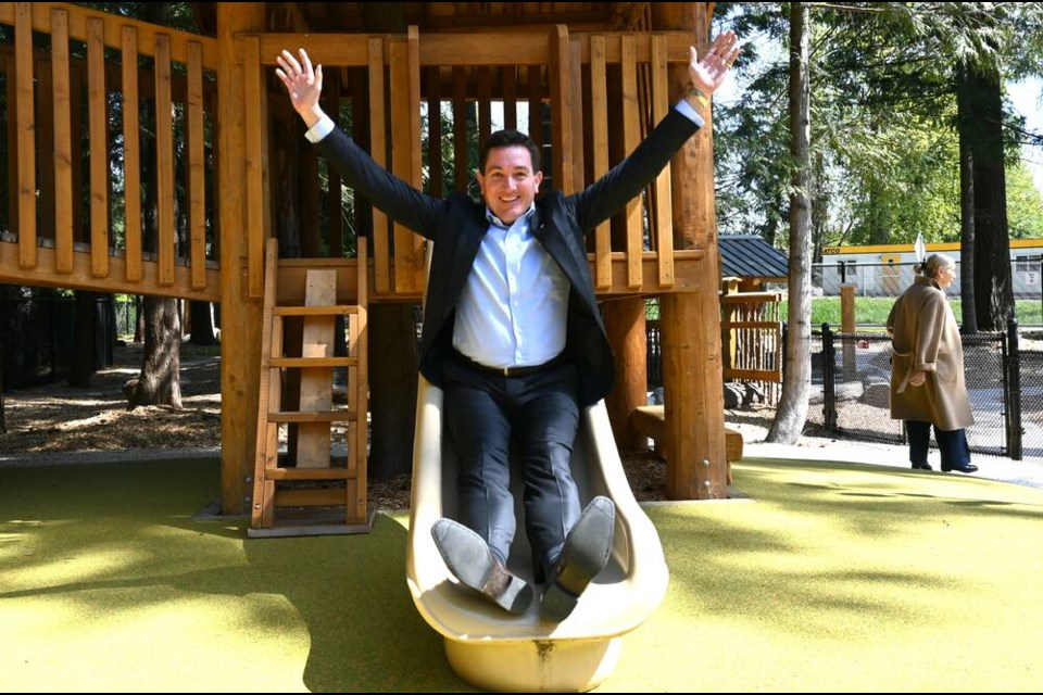 Yuri Fulmer, Capilano University chancellor, slips down a slide at playground near the Fulmer Family Centre for Childhood Studies building. | Abby Luciano / North Shore News 