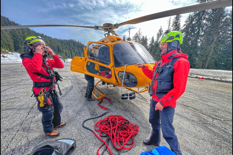 North Shore Rescue volunteers prepare to long-line rescue an injured skier from the Cypress Mountain area. | Pat Bell 