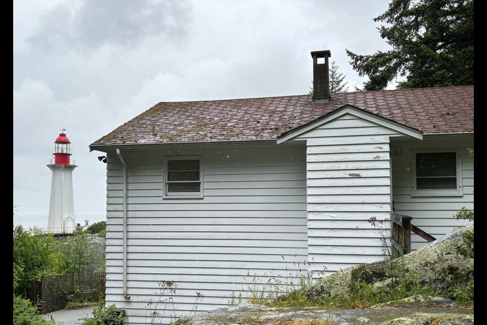 The paint is peeling and chipping away off the upper cottage in West Vancouver’s Lighthouse Park. Critics are calling on council to rent the homes out and maintain them. | Brent Richter / North Shore News 