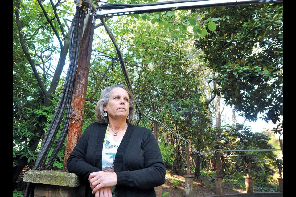North Shore Heritage president Jennifer Clay stands with the remnants of Park & Tilford Gardens’ brick colonnade walkway, which has been largely dismantled due to rot. | Paul McGrath / North Shore News 