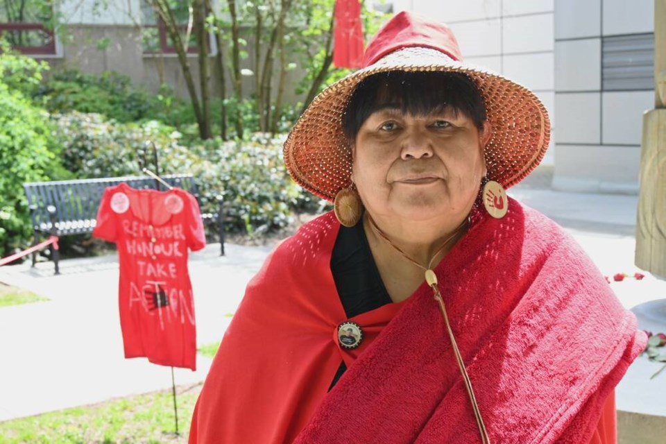 Squamish Nation Elder Doris Paul stands in front of the Strength and Remembrance pole outside the North Vancouver RCMP detachment Monday after the Red Dress Day ceremony. | Abby Luciano / North Shore News