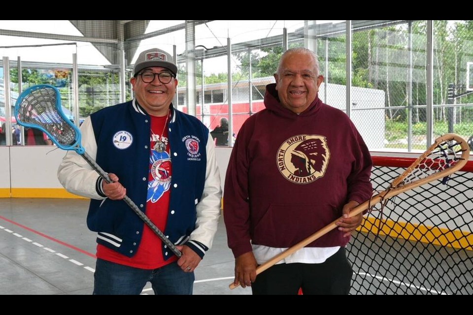 Squamish Nation councillor Sxwíxwtn (Wilson Williams) and coach Sam Seward hold their lacrosse sticks on the court feeling the anticipation of the grand opening of Ḵw’eshḵw’shétsutay̓ (Playing Place) Friday. | Abby Luciano / North Shore News 