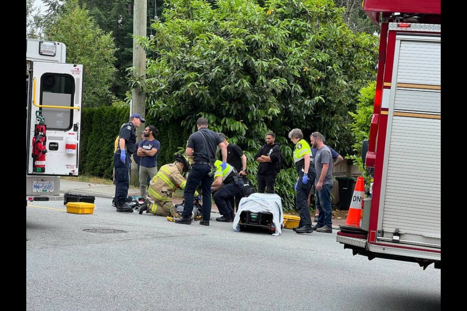 First responders attend to a pedestrian struck on Montroyal Boulevard around 4 p.m. Wednesday. | Pat Bell 