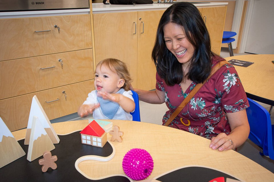 One-year-old Davi plays blocks with Bowinn Ma, North Vancouver-Lonsdale MLA and minister of infrastructure. | Nick Laba / North Shore News 