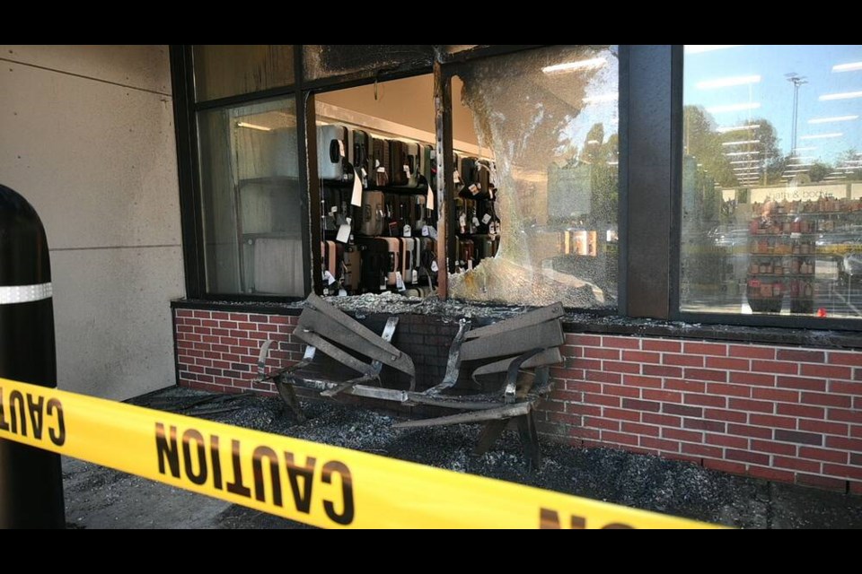 A photo from the scene shows damage to a bench and windows outside the Winners at the Park and Tilford Centre following a blaze Tuesday morning. | Abby Luciano / North Shore News