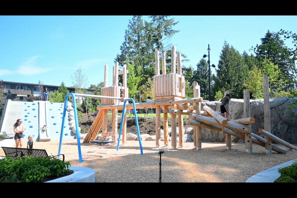 The new Topo Park in North Vancouver's Central Lonsdale neighbourhood features wooden play structures, a rock climbing wall, a saucer swing and a concrete slide. | Abby Luciano / North Shore News