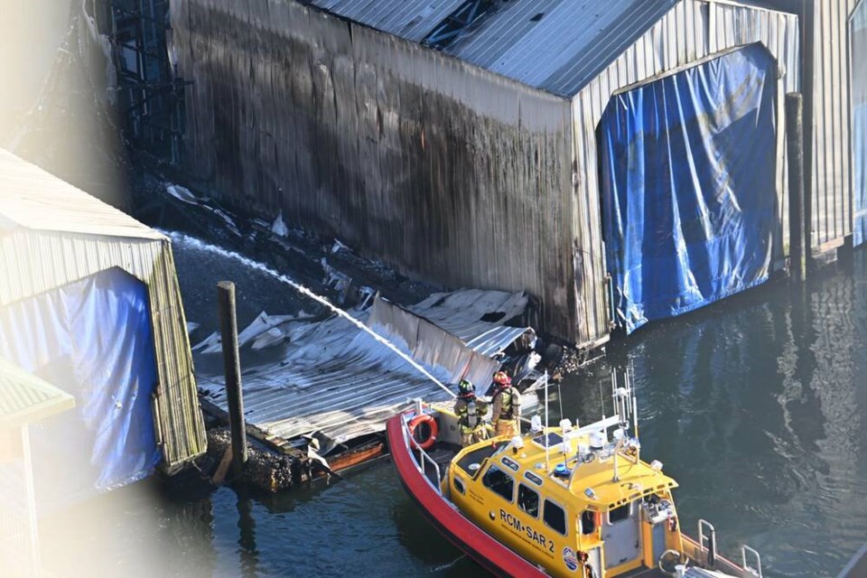 District of North Vancouver firefighters tackle the boat fire from a Royal Canadian Search and Rescue vessel in Lynnwood Marina, July 28. | Mark Teasdale 