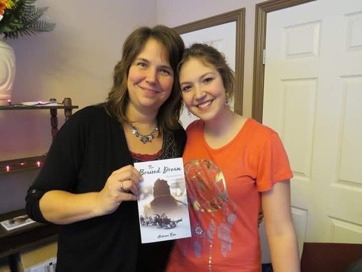 Alabama Yutzy (right) with her mom Wendy Yutzy (left) and her first publishes novel.
