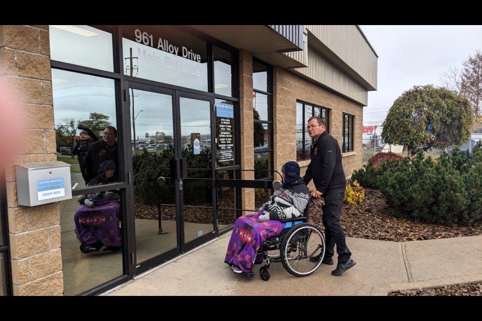 Howard Meshake and Jeannie Carpenter knock on the door to Community Care (Photo by Clint Fleury)