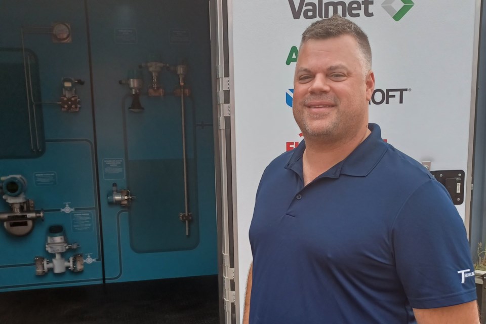 Ryan Gagnon, business development manager, poses in front of TransWest Process Solutions' "showcase trailer" on June 6, 2025, in Thunder Bay.