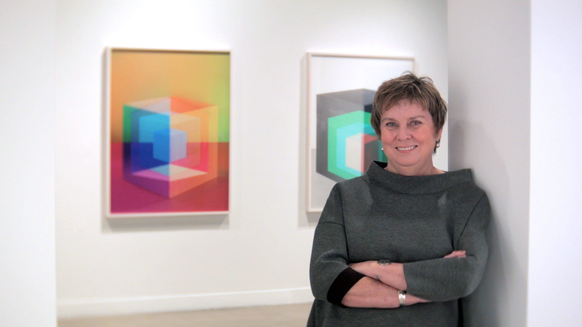 Marnie Fleming with short hair in a sweater in art gallery | Daniel McIntyre