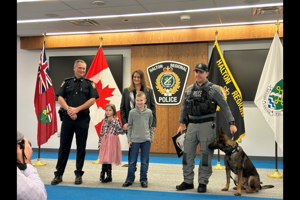 Const. Tidbal's wife and children (left), Const. Volaric and Blue (right)