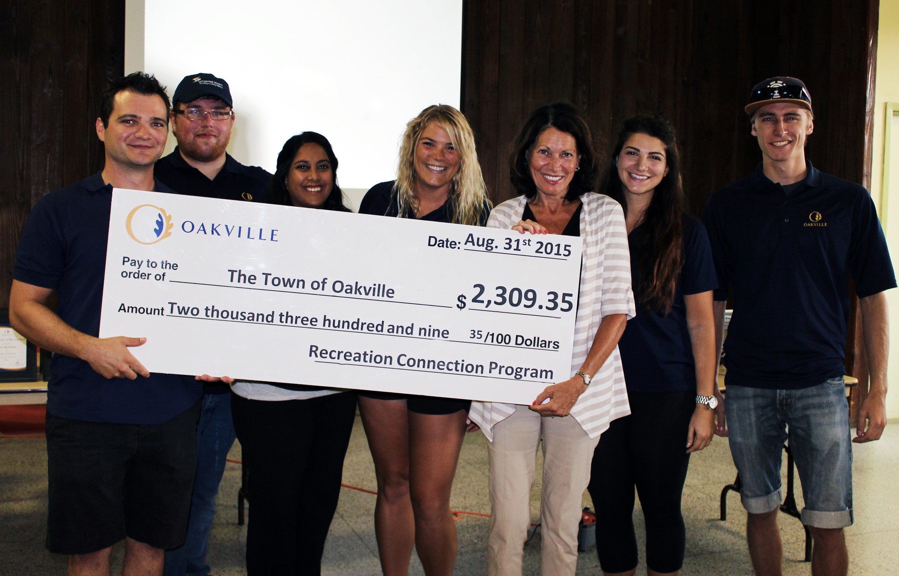 Group of People holding a presentation check | Town of Oakville
