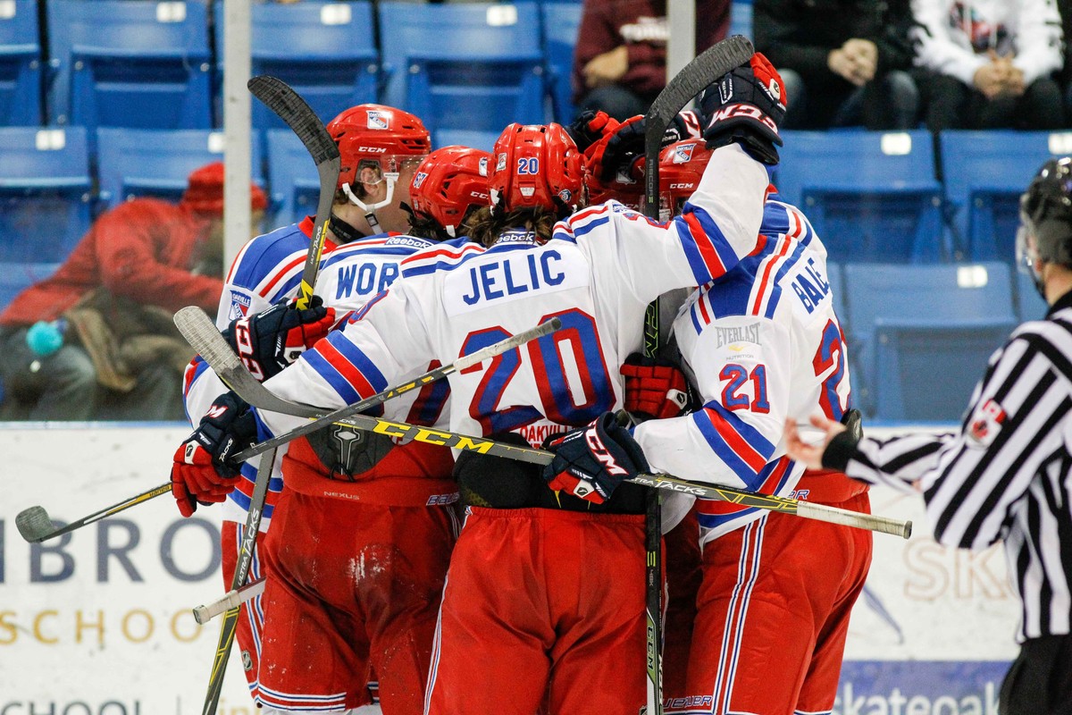 Hockey Players hugging on the ice | Kevin Sousa  -  OJHL Images