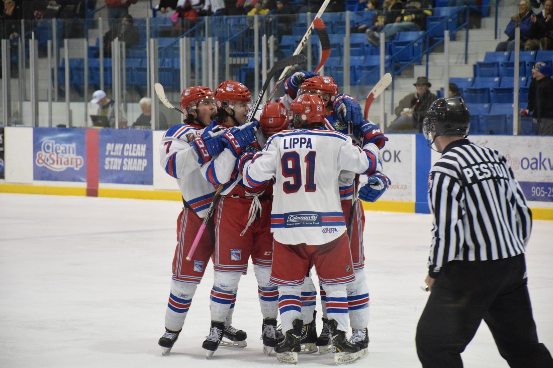 Oakville Blades in congratulatory hug on the Ice | Scott Ellis - The Hockey House