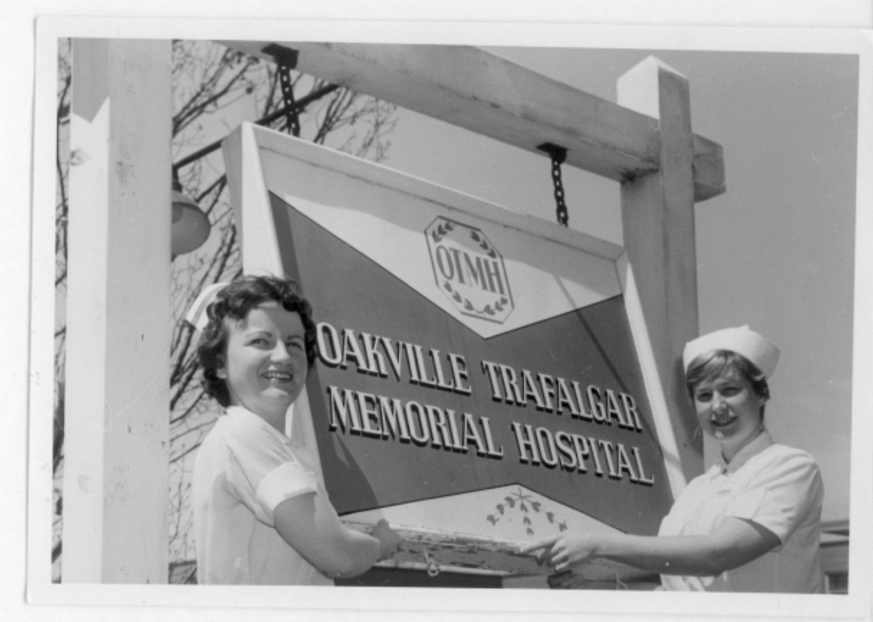 Oakville Trafalgar Memorial Sign hung by 2 nurses - 1950