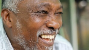 Face of older black man smiling |  Jojo Chintoh will be speaking to Oakville students on February 4, 2016.