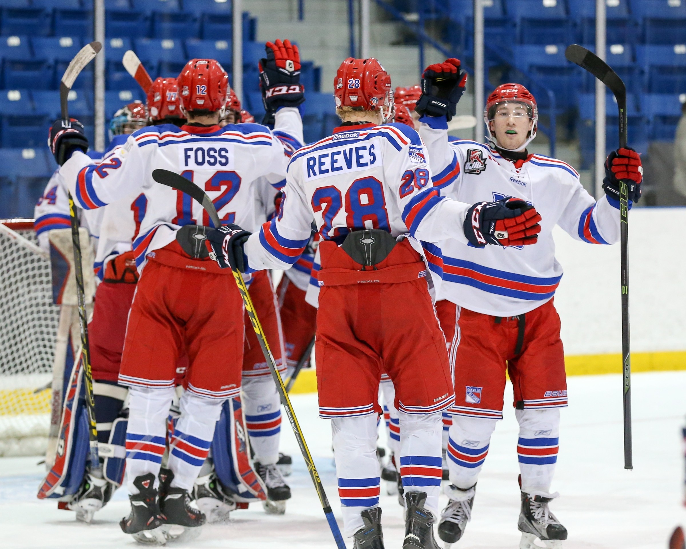Group of hockey players on the ice congratulating each other | Kevin Sousa  -  OJHL Images