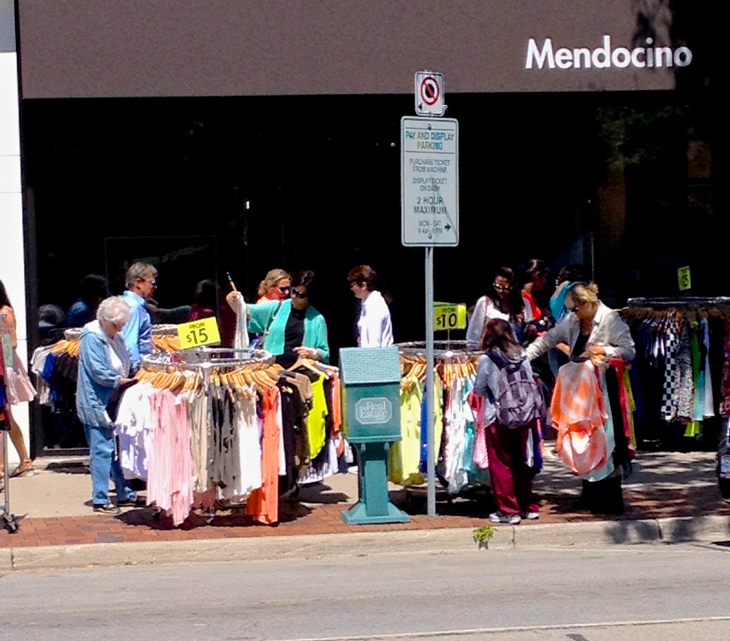 Shoppers enjoying the sidewalk sale outside Mendecino | Oakville News