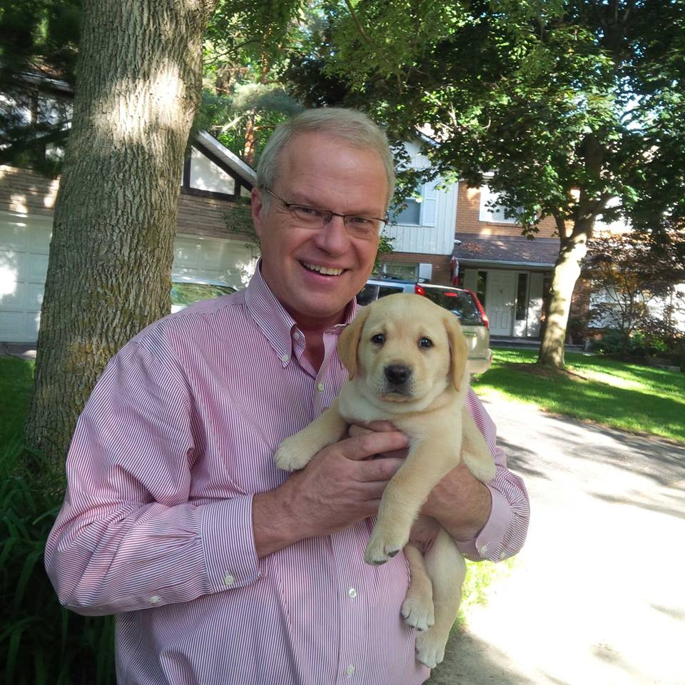 White male holding golden retriever puppy | Dave Gittings