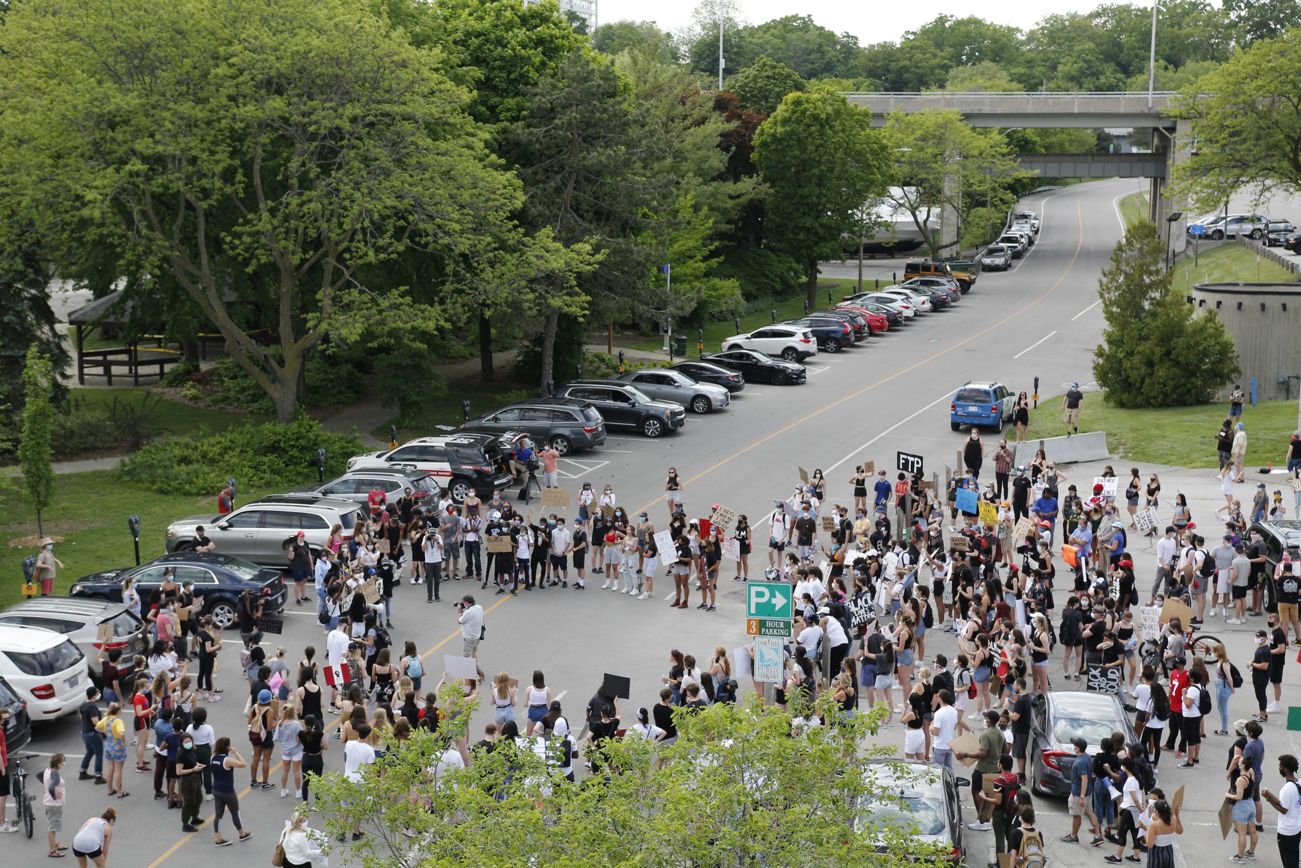 BLM march Oakville | The group listening to the march organizers speak in the parking lot behind the Central Branch of the Oakville Library. | Thomas Desormeaux
