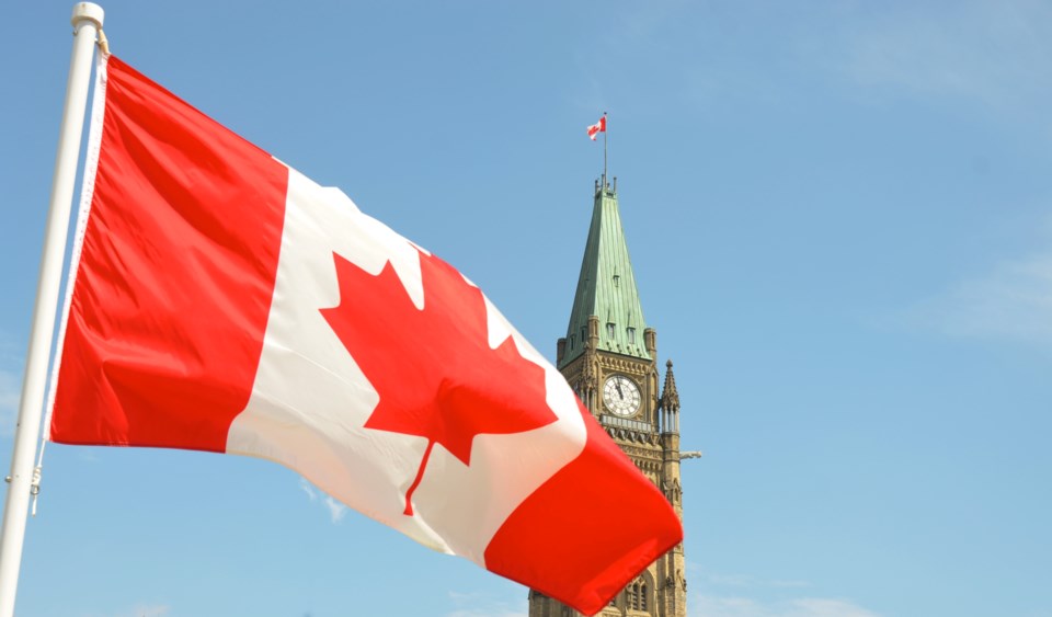 canadian-flag-parliament-hill-jason-hafso-unsplash