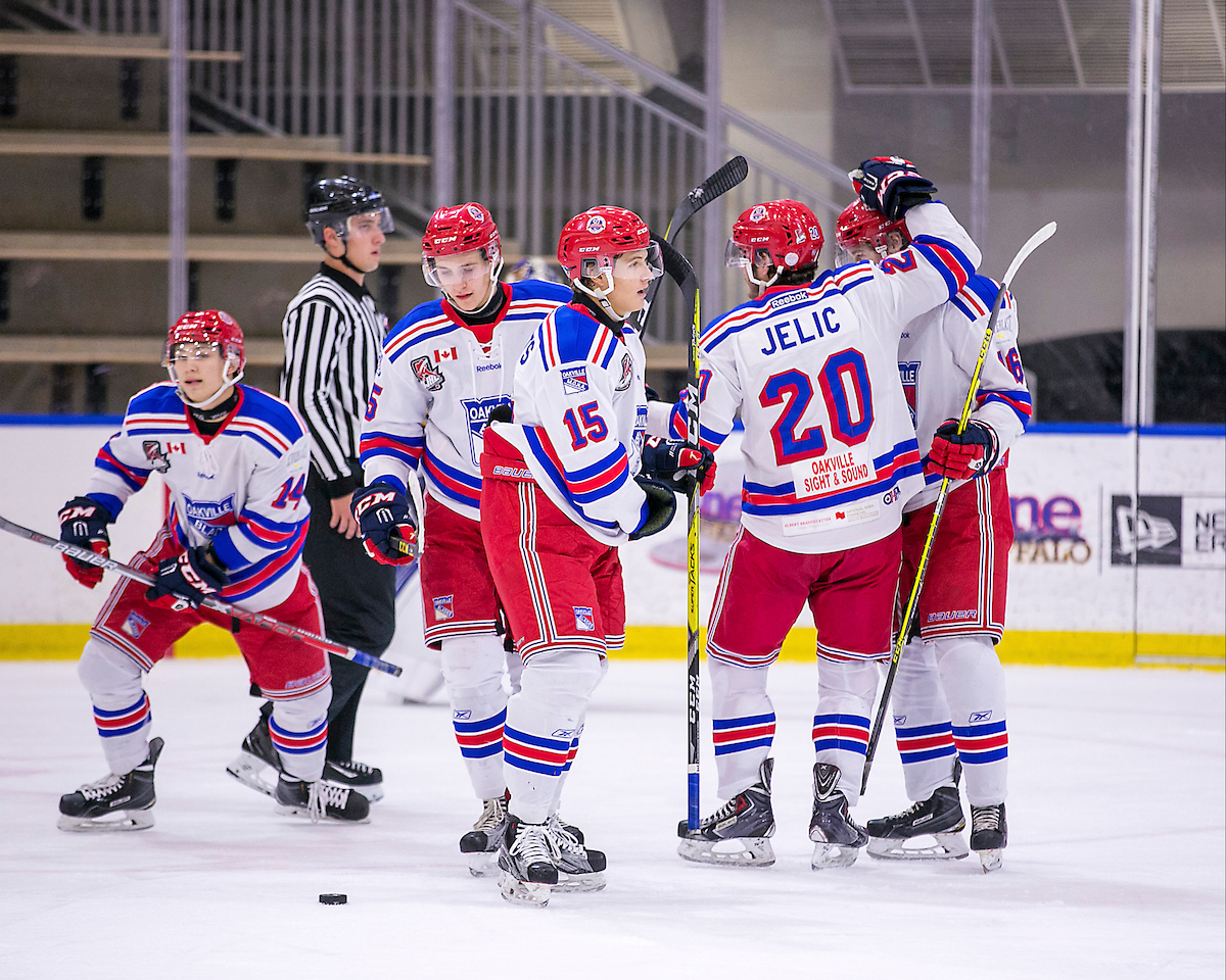 Matt Hayami #14 of the Oakville Blades scores on a power play goal. Assists by Evan Brown #16 and Daniel Jelic #20 of the Oakville Blades | Deb McGwin  -  OJHL Images