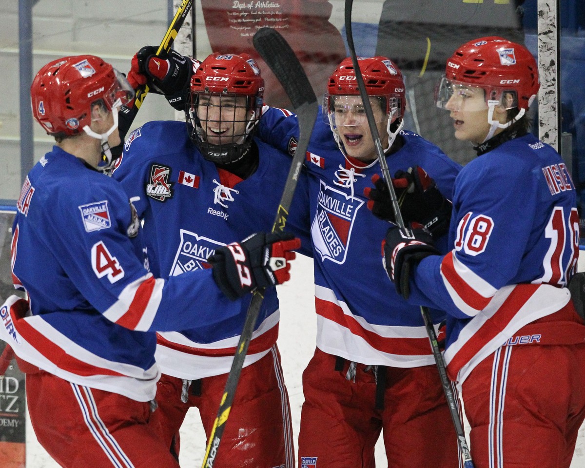 Ontario Junior Hockey League game action between Oakville and St. Michaels. Ethan Nother #17 of the Oakville Blades celebrates his second period goal with teammates. | Photo by Kevin Sousa - OJHLimages