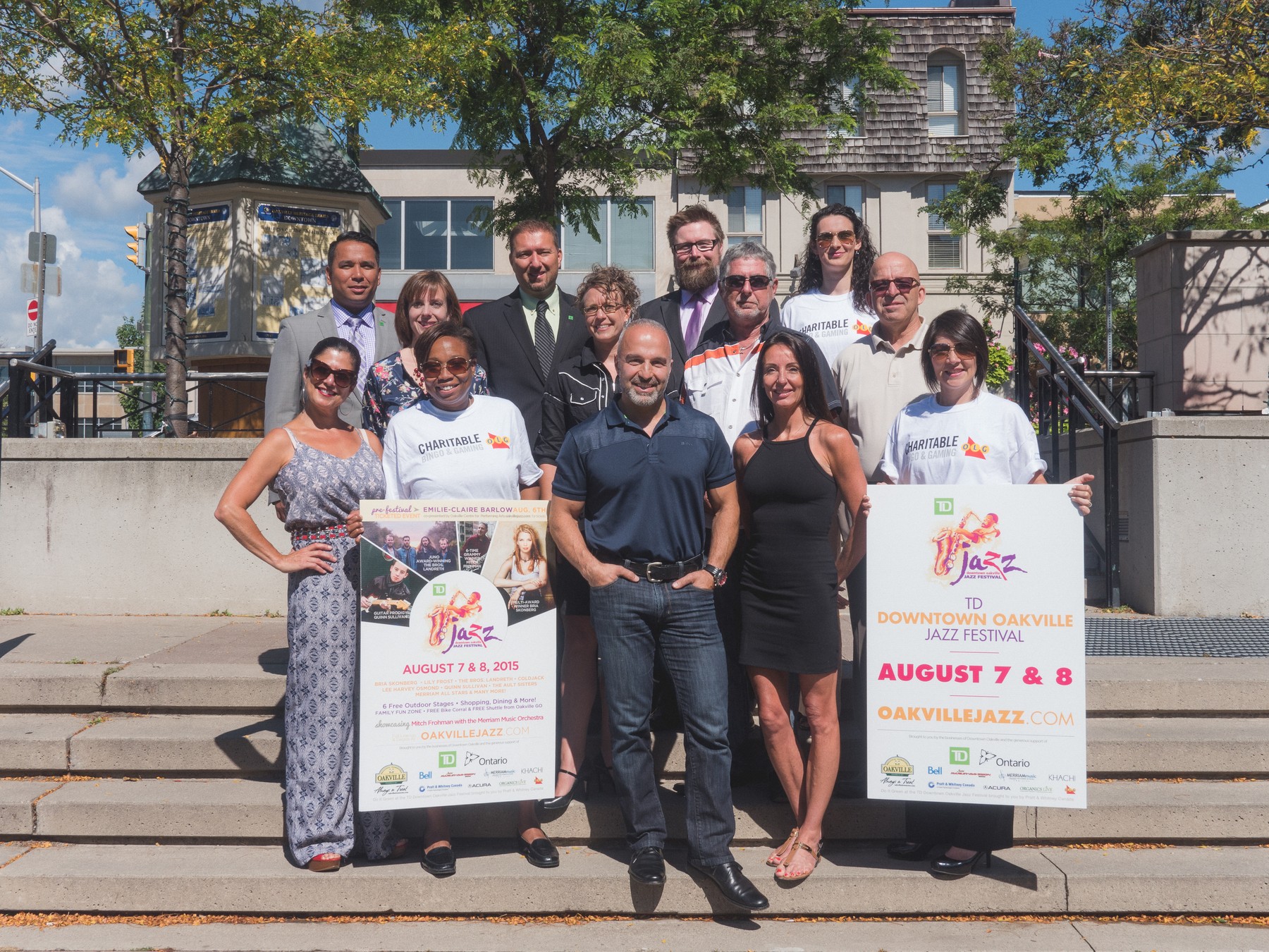 people on steps with Jazz Festival Sign | Downtown Oakville BIA