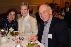 two ladies and a white hair gentleman in business attire at a table | Mary Saunders, Linda and Spence Williams Enjoying an Evening at the Oakville Conference Centre and Speaker, Stephen Leahy; Photo Credit: Janet Bedford | Janet Bedford