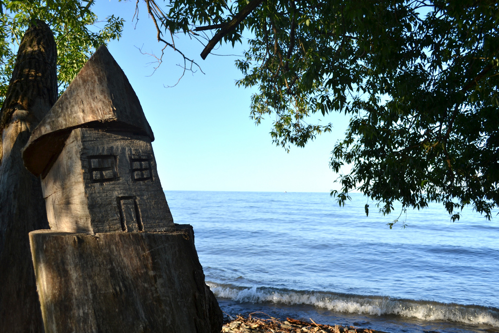 Block of wood by lake ontario carved to represent a house | n.karim
