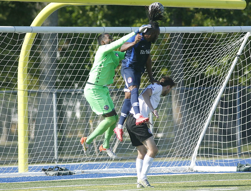 Khody Ellis climbs the ladder | Blue Devils attacker Khody Ellis soars to beat Praveen Ahilan to a ball in the air and give Oakville a 2-1 lead in the first half. | Paul Hendren