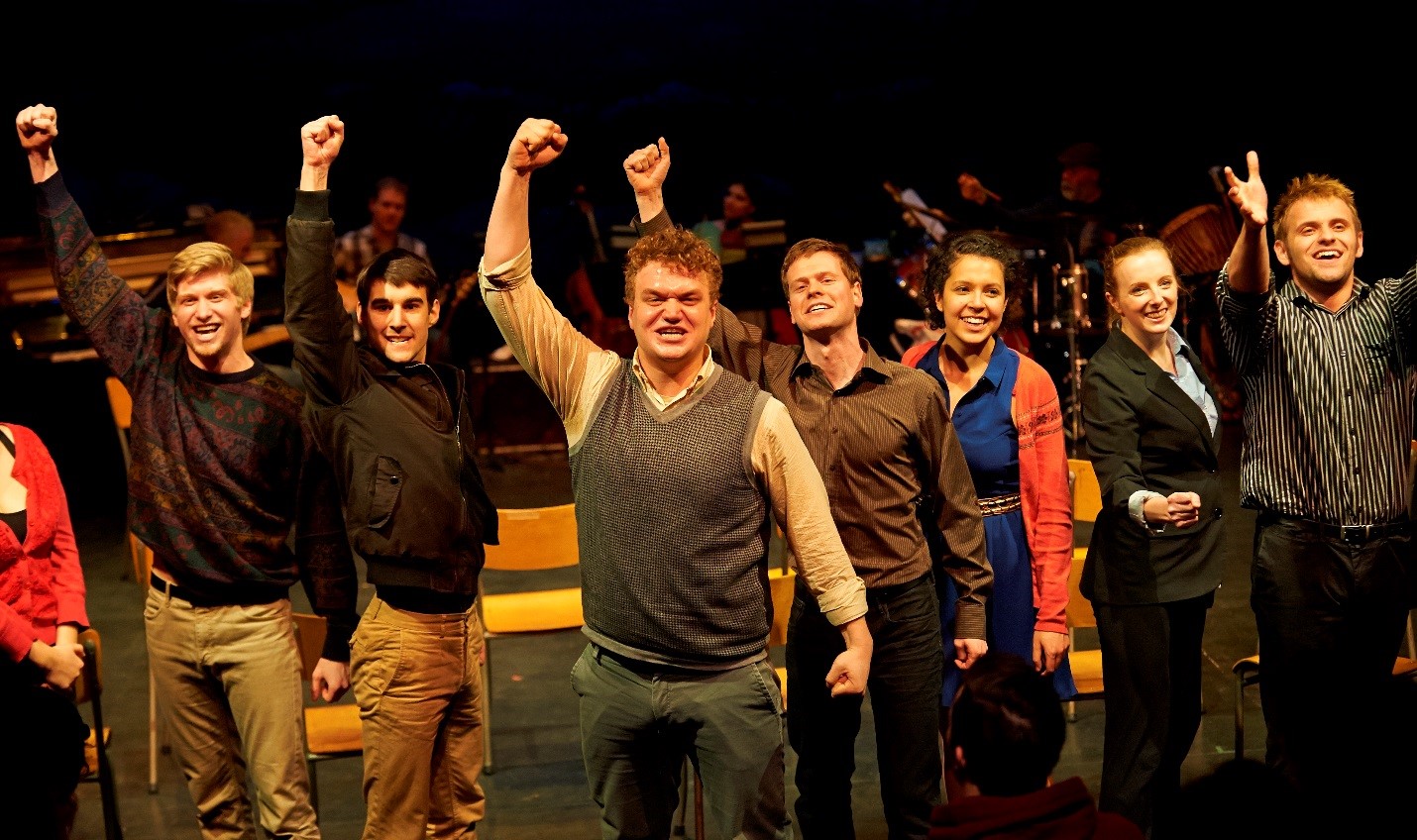 Theatre students dressed casually with right arms raised with fists | John Jones