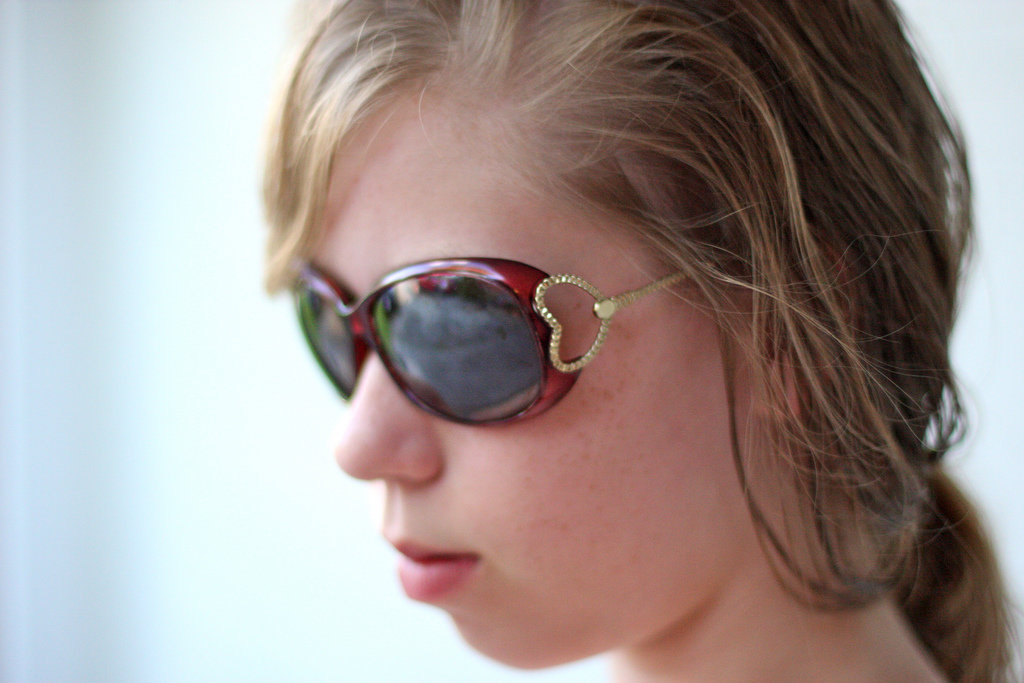 Head of young lady with sunglasses on | kevin dooley  -  Foter  -  CC BY