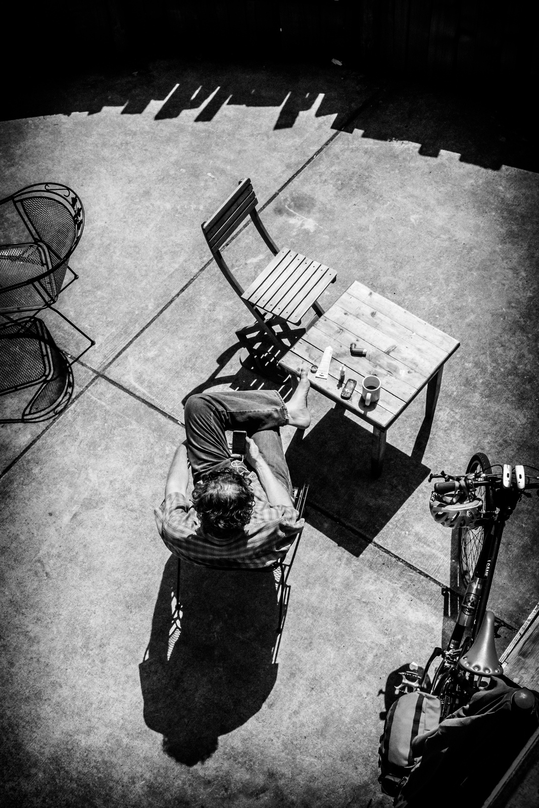 B/W top view of man on patio reading | Joris_Louwes  -  Foter  -  CC BY 2.0