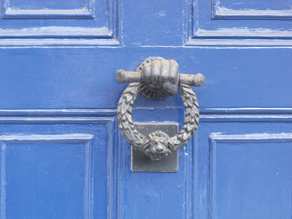 Community Blue door with knocker | ell brown via Source  -  CC BY