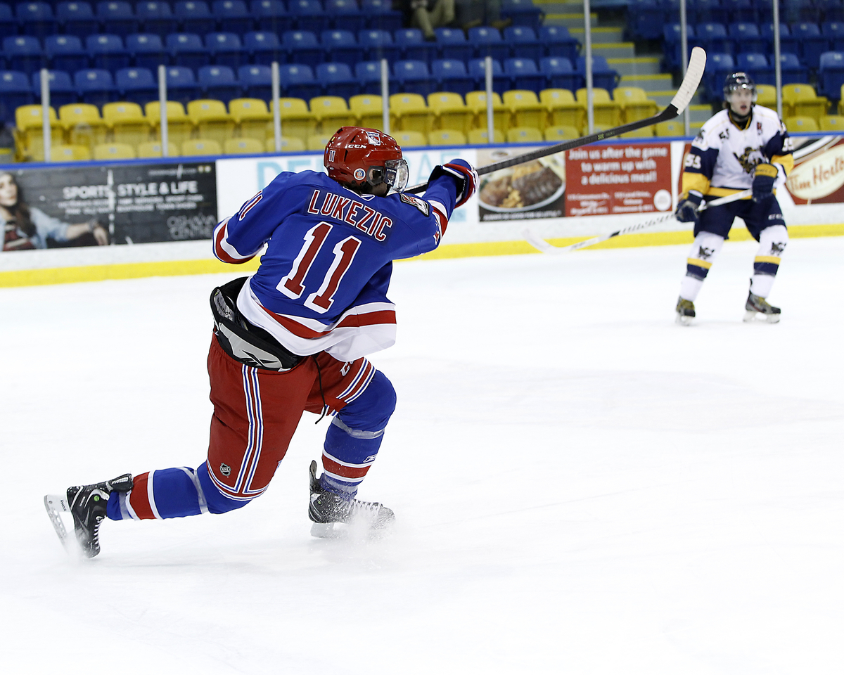 Brandon Lukezic #11 of the Oakville Blades Hockey Club shoots the puck from the blue line | Tim Bates  -  OJHL Images