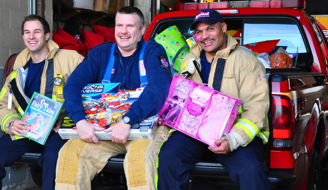 Firefighers holding unwrapped gifts | Oakville Firefighters