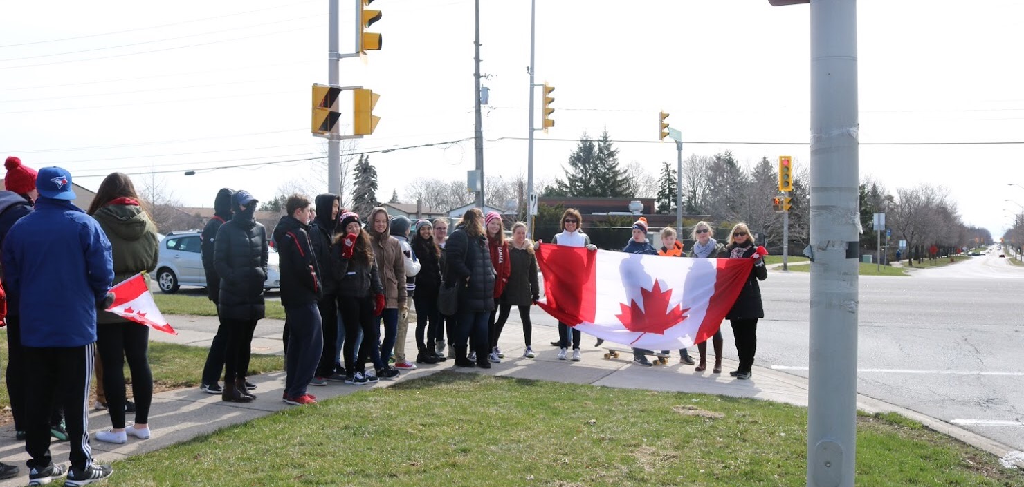 Students walking with Canadian Flag | Erin Leahy