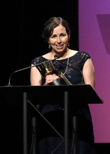 white woman with dark hair in ball gown at podium | Allison Rutland accepts the Annie Award for Outstanding Achievement, Character Animation in a Feature Production for Inside Out; Photo Credit: David Yeh, courtesy of the Annie Awards | David Yeh, courtesy of the Annie Awards