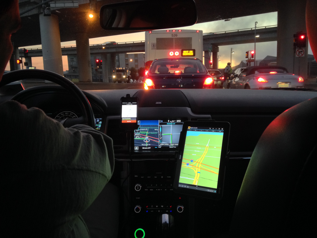 Uber Driver looking from the back seat of a car driven by and UBER Driver | {Guerrilla Futures | Jason Tester} via Foter.com  -  CC BY-ND