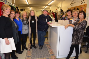 Ladies in a clothing shop standing for group picture |  Fun at the Nearly New Shop at 200 Kerr St. Oakville - Yes - the men have fun shopping here - So do the women! Photo Credit: Janet Bedford