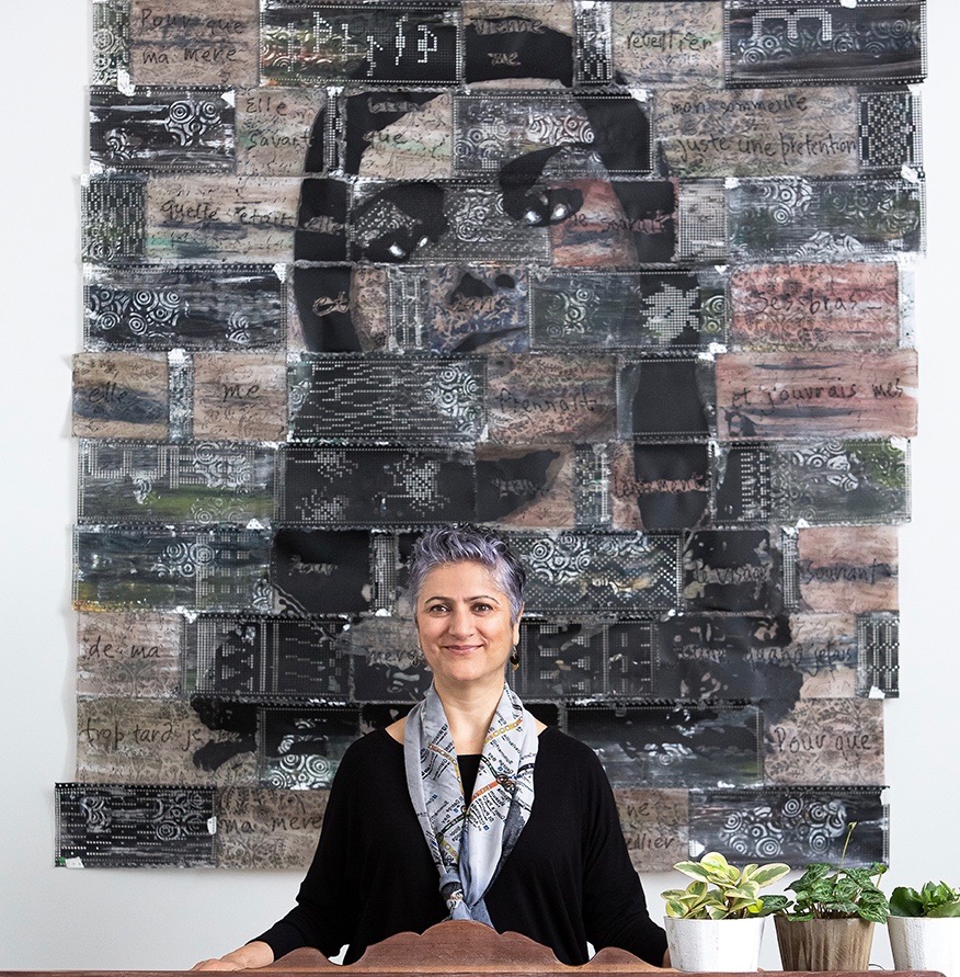 Anu Raina standing in front of her artwork "Chapter 2, Page 1", dedicated to her late mother. The piece was displayed at Toronto Pearson International Airport in 2010. | Andes Lo