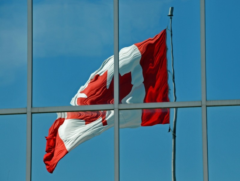Canadian Flag waving reflected off mirrored building | archer10 (Dennis)  -  Source  -  CC BY-SA