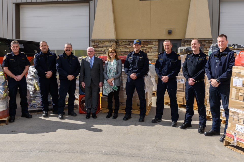 Members of Foothills County Fire Department and Foothills Council with equipment donated from the county at the Heritage Pointe fire station on March 24, 2022. (Robert Korotyszyn/OkotoksToday.ca)