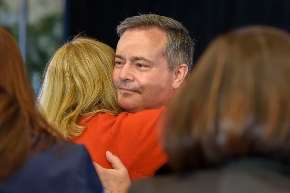 Alberta Premier Jason Kenney hugs supporters after announcing he will strep down as Premier and leader of the United Conservative Party after leadership review results were announced at Spruce Meadows in Calgary on May 18.