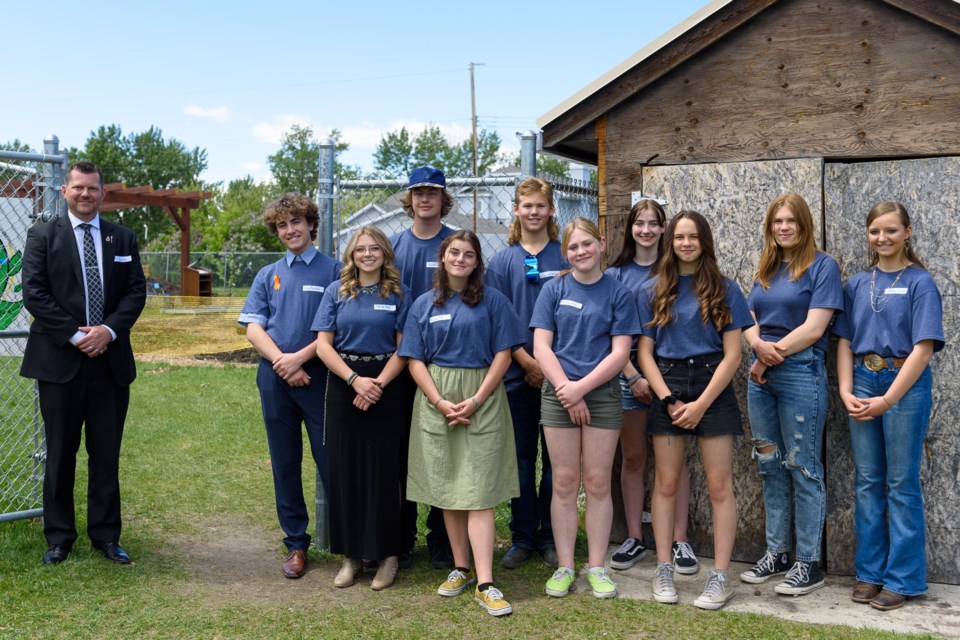 Highwood MLA RJ Sigurdson, left, is pictured with students in the Oilfields High School Sustainability Program at the school in Black Diamond on June 10. Sigurdson cut the ribbon to officially open the garden and composting facility, part of the school's student-led sustainability initiative. 