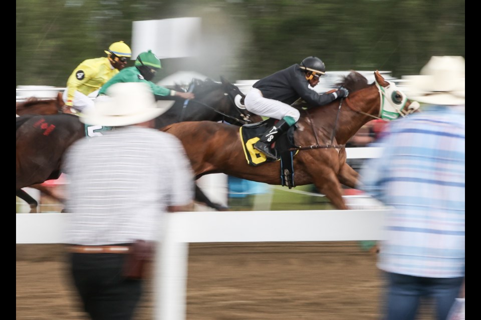 Horses fly down the track during the Millarville Races on July 1, 2022. After a two-year hiatus due to the pandemic, the races made a return to packed stands and a full day of entertainment last year.
