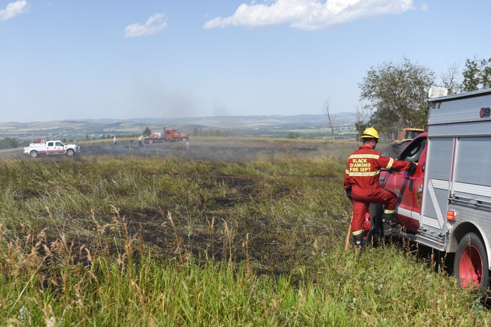 Crews from Turner Valley and Black Diamond Fire departments responded to an out-of-control grass fire on Range Road 30 south of 466 Avenue West in Foothills County on Aug. 12. Firefighters credit nearby ranchers for quickly acting to fight the fire until crews arrived.