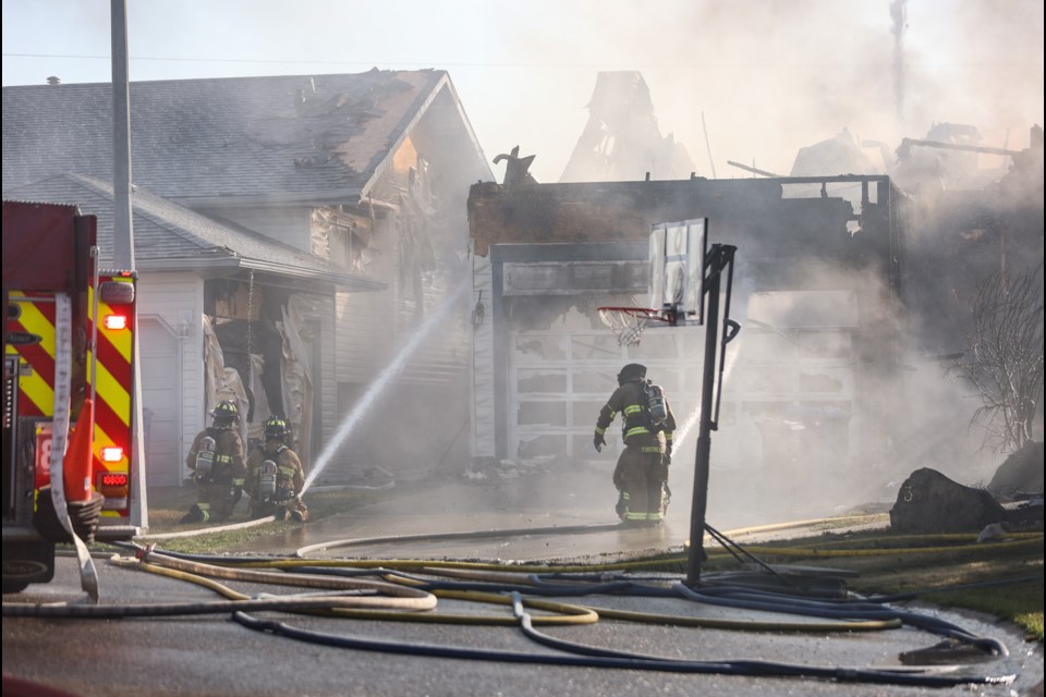 Emergency crews battle a blaze that consumed two homes in Sheep River Place on Sept. 4. No people were injured, but a dog is unaccounted for and adjacent homes suffered significant superficial damage.